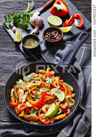 chicken fajitas with bell peppers, onion, spices chicken fajitas with bell peppers, onion, spices 102402037