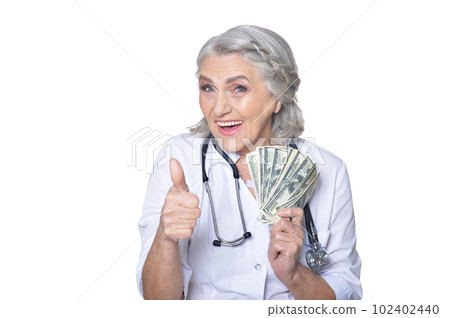 Smiling senior doctor showing thumbs up on white background Smiling senior doctor showing thumbs up on white background 102402440
