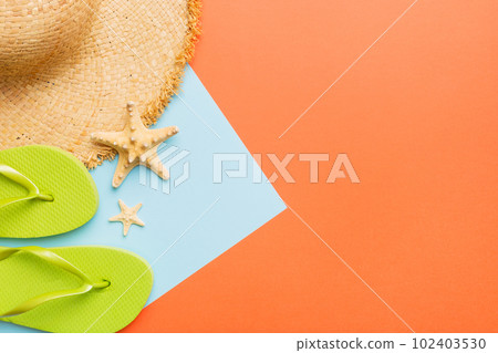 Summer vacation concept flat lay. straw hat beach accessories and flip flop top view. Space for text. travel concept 102403530