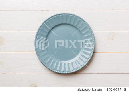 Top view of empty grey plate on wooden background. Empty space for your design Top view of empty grey plate on wooden background. Empty space for your design 102403546