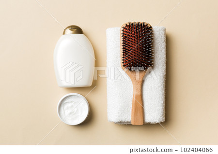 cosmetic for hair care, cream and towel on a colored background top view. flat lay 102404066