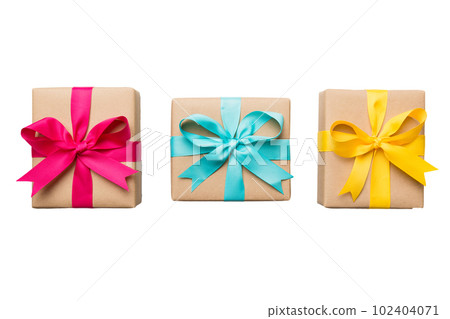 Holiday present box on a Isolated. Gift box with colored bow on white background top view close up Holiday present box on a Isolated. Gift box with colored bow on white background top view close up 102404071