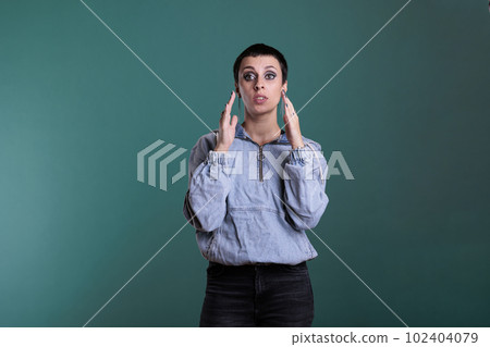 Angry unhappy young adult having agressive emotion wanting to screem while posing in studio standing over isolated background. Stressed worried caucasian female having mental breakdown 102404079