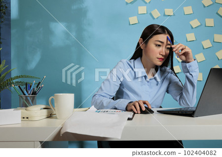 Thoughtful business woman with ideas to create a report on laptop, feeling pensive and thinking the best way to create marketing strategies. Concentrated worker pondering at work station. Thoughtful business woman with ideas to create a report on laptop, feeling pensive and thinking the best way to create marketing strategies. Concentrated worker pondering at work station. 102404082