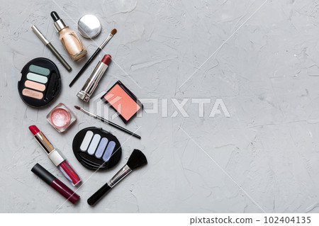 Professional makeup tools. Top view. Flat lay. Beauty, decorative cosmetics. Makeup brushes set and color eyeshadow palette on table background. Minimalistic style 102404135