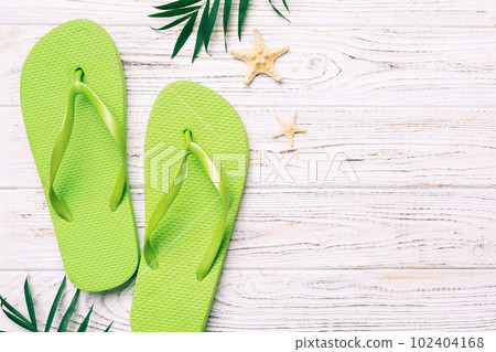 Flat lay composition with flip flops and seashell on colored background. Space for text top view Flat lay composition with flip flops and seashell on colored background. Space for text top view 102404168