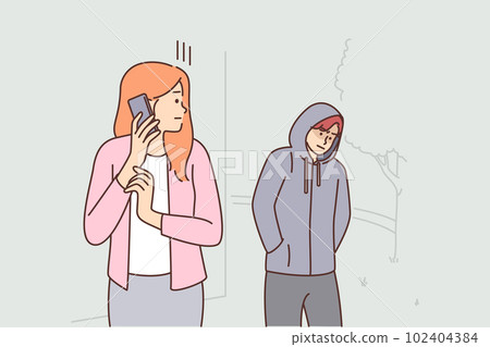 Frightened woman with phone looks back at stalker and calls 911 to call police for help Frightened woman with phone looks back at stalker and calls 911 to call police for help 102404384