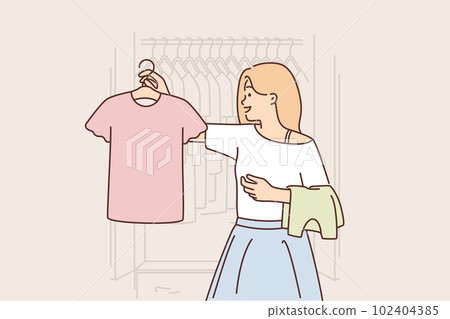 Woman chooses clothes from wardrobe going to party or sorting out t-shirts for thrift store Woman chooses clothes from wardrobe going to party or sorting out t-shirts for thrift store 102404385