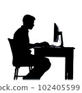 A simple silhouette of a male desk worker sitting and doing paperwork using a computer 102405599