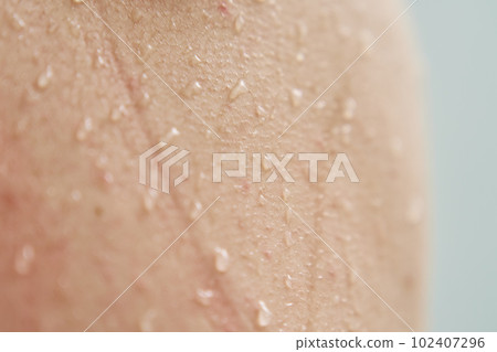 Female body skin with water drops in shower Female body skin with water drops in shower 102407296