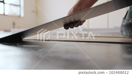 The process of laying laminate in a new apartment. Overview of the process of installation and installation of a new floor. 102408012