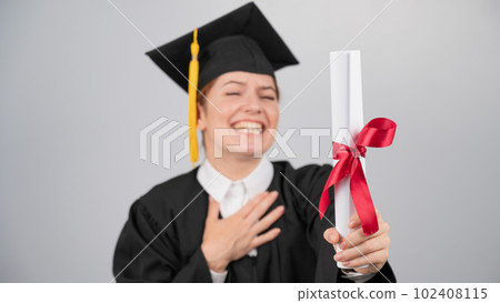 Smiling woman in graduation gown holding diploma on white background. Smiling woman in graduation gown holding diploma on white background. 102408115