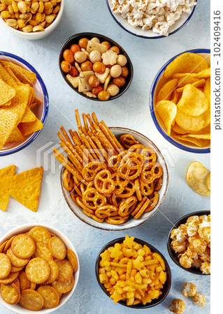 Salty snacks, party mix. A variety of crispy appetizers, shot from the top Salty snacks, party mix. A variety of crispy appetizers, shot from the top 102409416