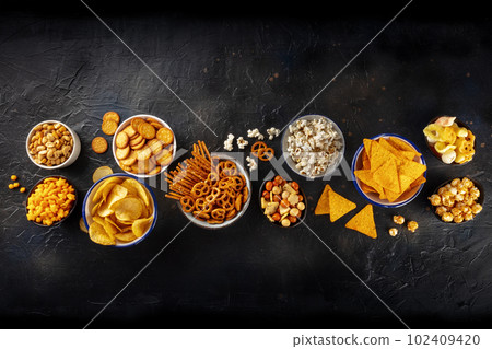 Salty snacks, party mix. An assortment of crispy appetizers, shot from above 102409420