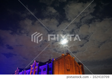 Yokohama Red Brick Warehouse building. Bright moon in the night sky Yokohama Red Brick Warehouse building. Bright moon in the night sky 102410709
