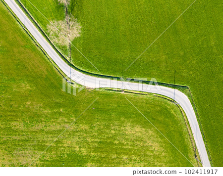Aerial view of Colorful landscape with road in beautiful green meadows in spring. Top view from Aerial view of Colorful landscape with road in beautiful green meadows in spring. Top view from 102411917