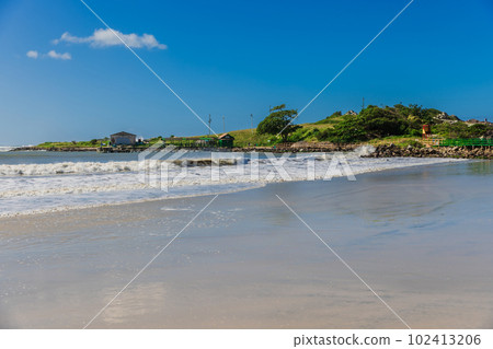 Beach with coastline, pier and ocean in sunny day. Holiday beach in Brazil, Florianopolis Beach with coastline, pier and ocean in sunny day. Holiday beach in Brazil, Florianopolis 102413206