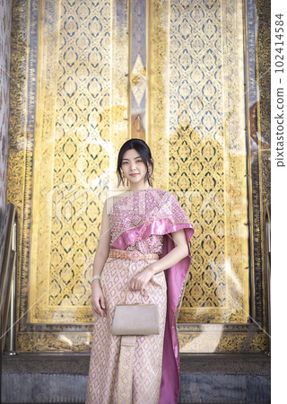 Beautiful Asian girl in Thai traditional costume at temple Beautiful Asian girl in Thai traditional costume at temple 102414584