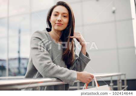 Beautiful girl in a summer city. Lady with shopping bags Beautiful girl in a summer city. Lady with shopping bags 102414644