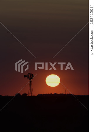 Windmill in countryside at sunset, Pampas, Patagonia,Argentina. 102415054