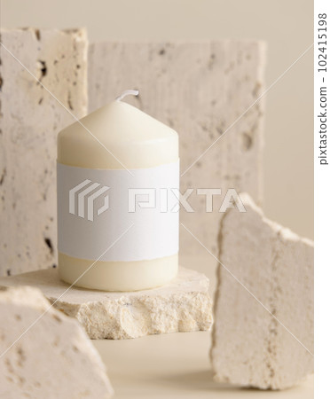 Candle with label on beige near cream travertine stones, Close up. Packaging mock up Candle with label on beige near cream travertine stones, Close up. Packaging mock up 102415198