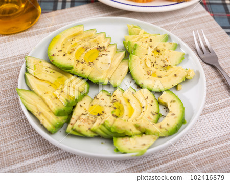 ripe avocado pulp cut into pieces sprinkled with lemon juice on a plate ripe avocado pulp cut into pieces sprinkled with lemon juice on a plate 102416879