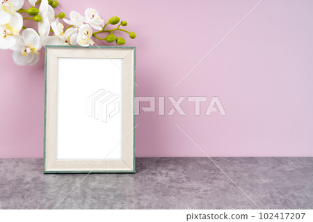 The Blank picture frame with white orchid flower on pink color background with copy space and clipping path for the inside. The Blank picture frame with white orchid flower on pink color background with copy space and clipping path for the inside. 102417207