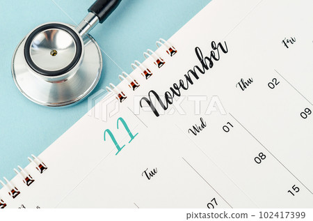 A November 2023 deskcalendar and medical stethoscope medical on blue background, schedule to check up healthy concepts. A November 2023 deskcalendar and medical stethoscope medical on blue background, schedule to check up healthy concepts. 102417399