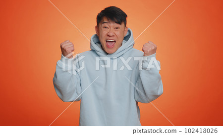 Asian chinese happy man celebrating success, winning, birthday, lottery jackpot goal achievemen Asian chinese happy man celebrating success, winning, birthday, lottery jackpot goal achievemen 102418026