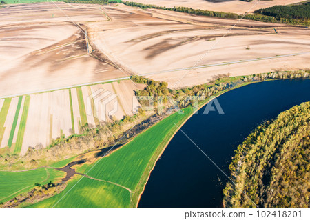 Aerial View Fields And River Landscape In Sunny Spring Summer Day. Top View Of Nature, Bird's Eye View. Trees Standing In Water During Spring Flood floodwaters. woods in Water deluge During A Spring 102418201