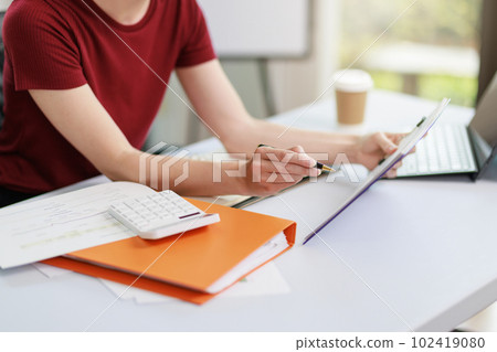 Concept of business office woman working,Closeup businesswoman checking her invesment plan with analyzing document and business investment graph data by using calculator and laptop Concept of business office woman working,Closeup businesswoman checking her invesment plan with analyzing document and business investment graph data by using calculator and laptop 102419080