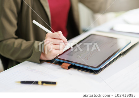 Concept of business office woman working,Closeup businesswoman checking her invesment plan with analyzing document and business investment graph data by using calculator and laptop Concept of business office woman working,Closeup businesswoman checking her invesment plan with analyzing document and business investment graph data by using calculator and laptop 102419083