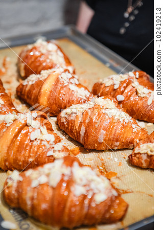 ready-made croissants on a baking sheet 102419218