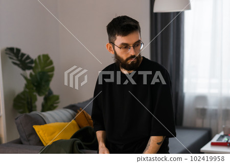 Sad man pondering about his life after a relationship breakup or bipolar disorder copy space - depression asthenia , mental problem and anxiety disorder concept 102419958