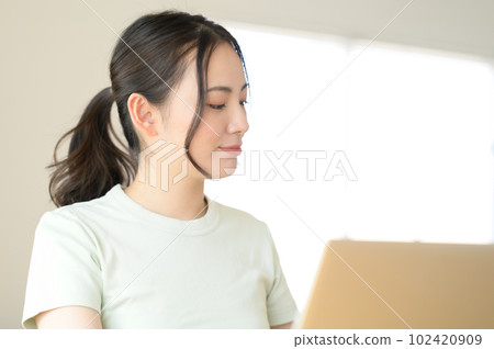 young woman sitting in front of a laptop young woman sitting in front of a laptop 102420909