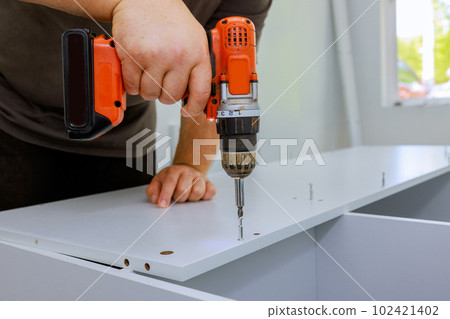 An process of assembling furniture closet cabinets that needed to be installed by carpenter 102421402
