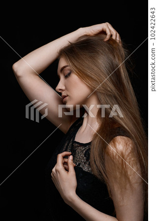 gorgeous brunette woman with long hair in black dress 102422643