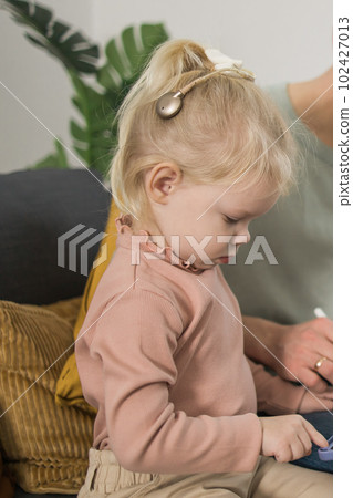 Funny baby with cochlear implant. Hear aid and medicine innovating technology and diversity concept 102427013