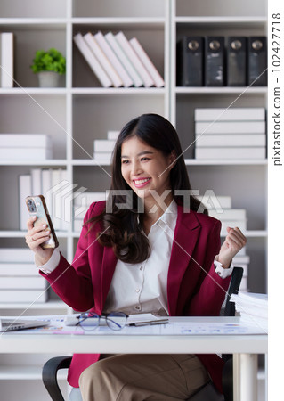 Happy executive sales business woman cheering excited in celebration after good news. achieving goals, success concept 102427718