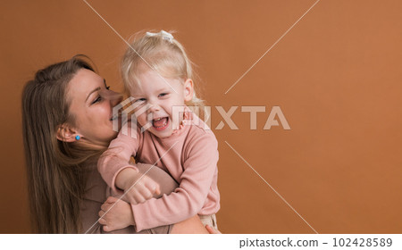 Deaf child girl with cochlear implant studying to hear sounds and have fun with mother copy space - recovery after cochlear Implant surgery and rehabilitation concept 102428589