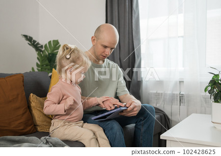 Deaf kid with hearing aid cochlear implant have fun with father - Hear aid and medicine innovating technology and diversity concept 102428625