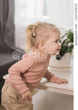 Funny baby with cochlear implant. Hear aid and medicine innovating technology and diversity concept Funny baby with cochlear implant. Hear aid and medicine innovating technology and diversity concept 102428679