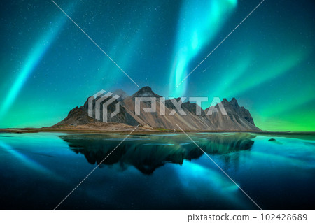 Aurora borealis Northern lights over famous Stokksnes mountains Aurora borealis Northern lights over famous Stokksnes mountains 102428689