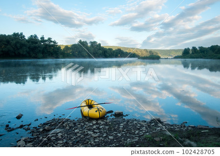 Yellow packraft on beautiful sunrise river Yellow packraft on beautiful sunrise river 102428705