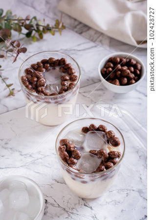 Homemade milk bubble tea with ice in glasses on the table vertical view Homemade milk bubble tea with ice in glasses on the table vertical view 102428727