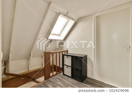 a small room in a house with wood floors and white walls, there is an air condition heater on the floor a small room in a house with wood floors and white walls, there is an air condition heater on the floor 102429096