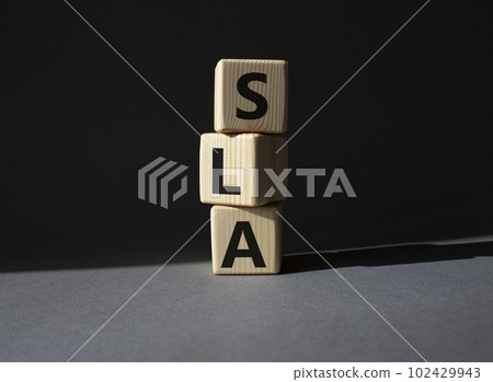 SLA - Service Level Agreement. Wooden cubes with word SLA. Beautiful grey background. Business and Service Level Agreement concept. Copy space. SLA - Service Level Agreement. Wooden cubes with word SLA. Beautiful grey background. Business and Service Level Agreement concept. Copy space. 102429943