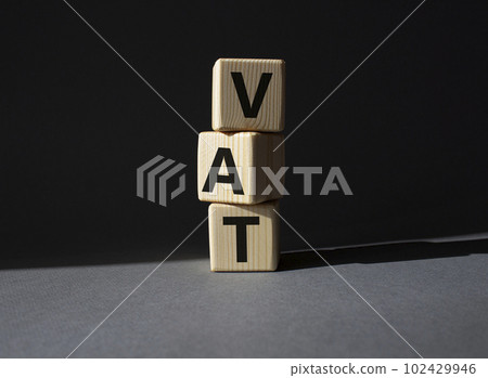 VAT - Value Added Tax symbol. Wooden cubes with word VAT. Beautiful grey background. Business and Value Added Tax concept. Copy space. VAT - Value Added Tax symbol. Wooden cubes with word VAT. Beautiful grey background. Business and Value Added Tax concept. Copy space. 102429946