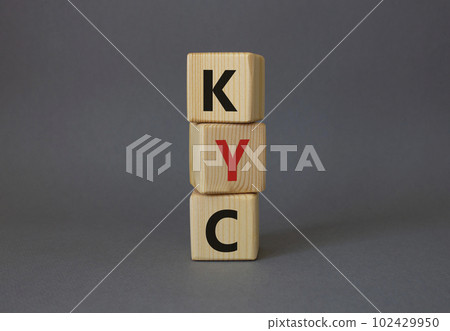 KYC - Know Your Customer. Wooden cubes with word KYC. Beautiful grey background. Business and Know Your Customer concept. Copy space. KYC - Know Your Customer. Wooden cubes with word KYC. Beautiful grey background. Business and Know Your Customer concept. Copy space. 102429950