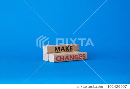 Make changes symbol. Wooden blocks with words Make changes. Beautiful blue background. Business and Make changes concept. Copy space. 102429997